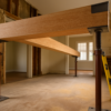 Engineered wood beam on temporary posts spanning a newly opened load bearing wall in a remodel